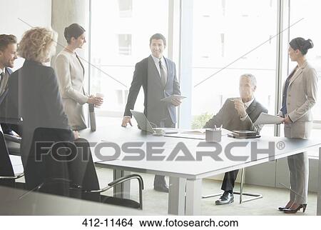 Picture - Business people talking in conference room. Fotosearch