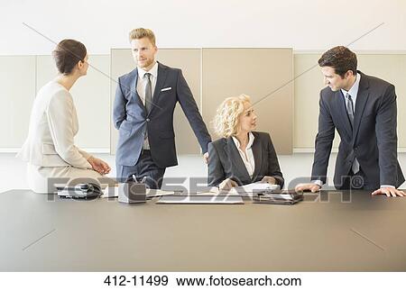 Stock Photo - Business people talking in meeting. Fotosearch