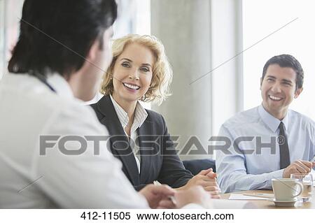 Stock Photography - Business people talking in meeting. Fotosearch
