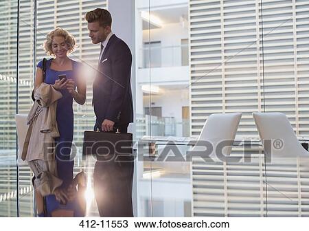 Stock Image - Business people talking in office. Fotosearch