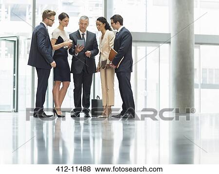 Stock Photo - Business people talking in office. Fotosearch