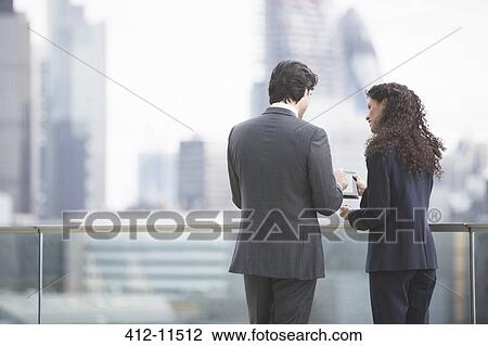 Business people using digital tablet outdoors View Large Photo Image Stock Image - Business people using digital tablet outdoors. Fotosearch