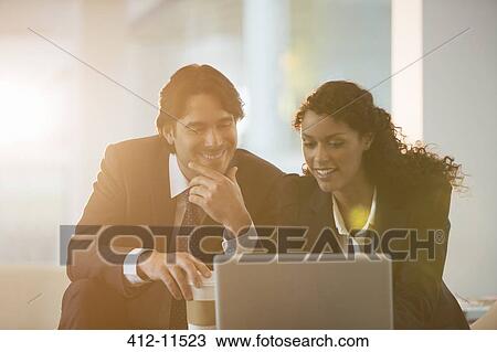 Business people using laptop in office View Large Photo Image Stock Image - Business people using laptop in office. Fotosearch