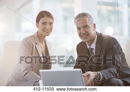 Business people using laptop in office View Large Photo Image Stock Image - Business people using laptop in office. Fotosearch