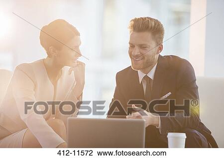 Business people using laptop in office View Large Photo Image Stock Image - Business people using laptop in office. Fotosearch