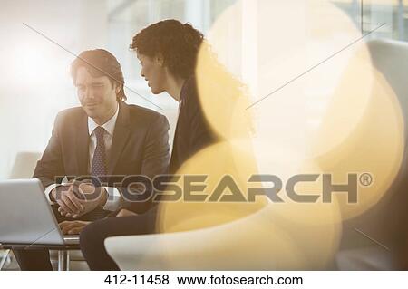 Business people using laptop in office View Large Photo Image Stock Photo - Business people using laptop in office. Fotosearch