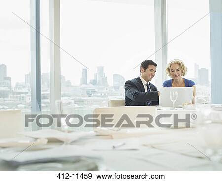 Business people using laptop in restaurant View Large Photo Image Stock Photo - Business people using laptop in restaurant. Fotosearch