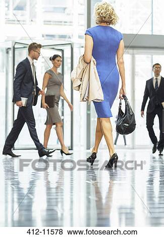 Business people walking in office lobby View Large Photo Image Stock Photo - Business people walking in office lobby. Fotosearch