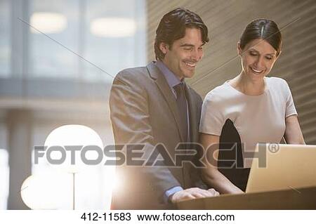Stock Image - Business people working in office. Fotosearch