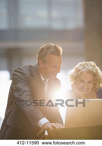 Stock Image - Business people working in office. Fotosearch
