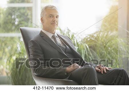 Businessman sitting in leather chair View Large Photo Image Stock Image - Businessman sitting in leather chair. Fotosearch