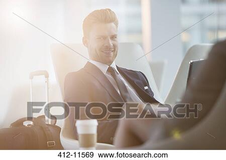 Businessman smiling in airport View Large Photo Image Stock Photo - Businessman smiling in airport. Fotosearch