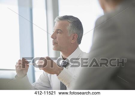 Stock Image - Businessman talking in meeting. Fotosearch
