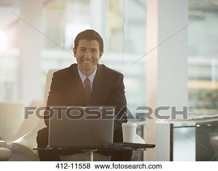 Businessman using laptop in office View Large Photo Image Stock Photo - Businessman using laptop in office. Fotosearch