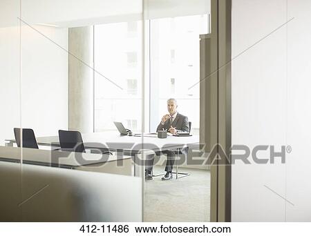 Businessman using laptop in office View Large Photo Image Stock Photograph - Businessman using laptop in office. Fotosearch