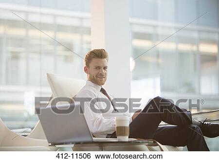 Stock Photograph - Businessman using laptop in office. Fotosearch