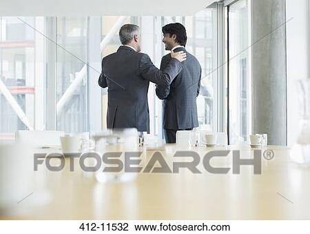 Stock Image - Businessmen talking in meeting. Fotosearch