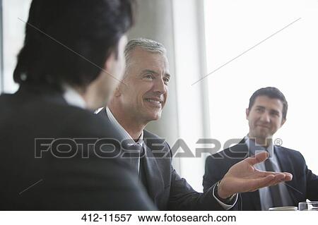 Stock Photo - Businessmen talking in meeting. Fotosearch