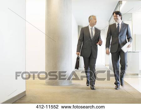 Businessmen talking in office corridor View Large Photo Image Stock Image - Businessmen talking in office corridor. Fotosearch