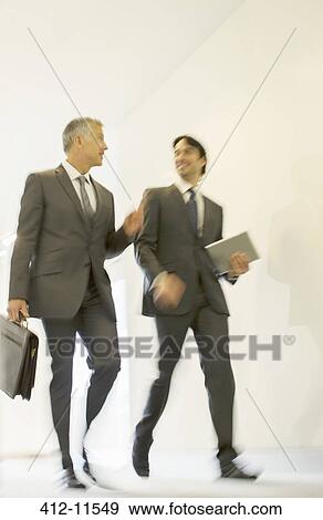 Stock Photo - Businessmen talking in office corridor. Fotosearch