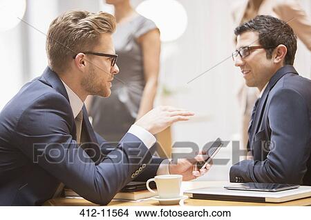 Businessmen talking in office View Large Photo Image Picture - Businessmen talking in office. Fotosearch