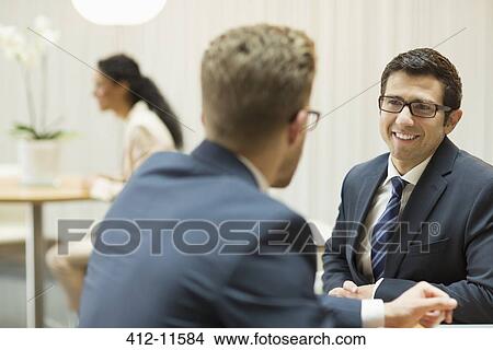 Businessmen talking in office View Large Photo Image Picture - Businessmen talking in office. Fotosearch