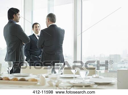 Businessmen talking in restaurant View Large Photo Image Stock Photo - Businessmen talking in restaurant. Fotosearch