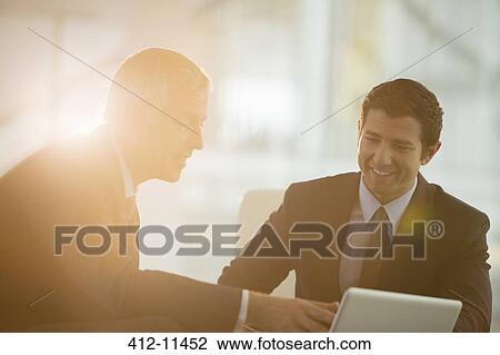 Businessmen using digital tablet in office View Large Photo Image Stock Image - Businessmen using digital tablet in office. Fotosearch