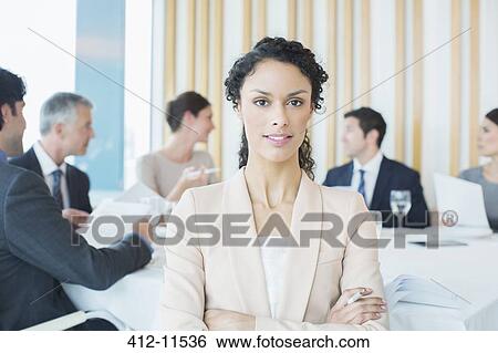 Stock Photograph - Businesswoman sitting in restaurant. Fotosearch