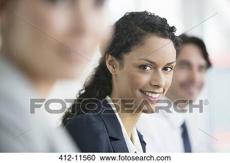 Businesswoman smiling in meeting View Large Photo Image Stock Image - Businesswoman smiling in meeting. Fotosearch