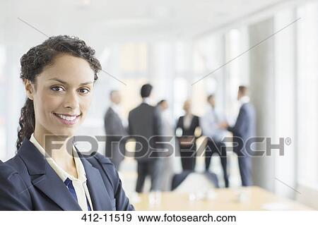 Stock Photo - Businesswoman smiling in meeting. Fotosearch