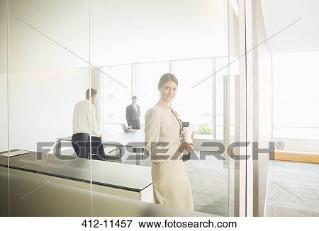 Stock Photo - Businesswoman smiling in office. Fotosearch