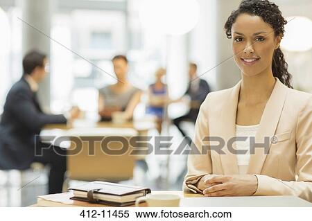 Businesswoman smiling in office View Large Photo Image Stock Photography - Businesswoman smiling in office. Fotosearch