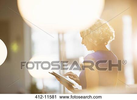 Businesswoman using digital tablet in office View Large Photo Image Stock Image - Businesswoman using digital tablet in office. Fotosearch