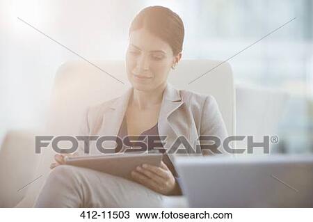 Stock Image - Businesswoman using digital tablet. Fotosearch