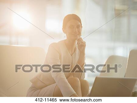 Businesswoman using laptop in office View Large Photo Image Stock Photography - Businesswoman using laptop in office. Fotosearch