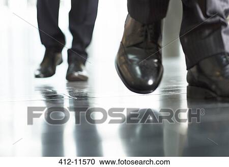 Stock Image - Close up of businessmens feet. Fotosearch