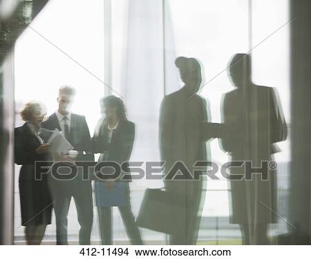 Reflection of business people talking in office View Large Photo Image Picture - Reflection of business people talking in office. Fotosearch