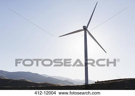 Picture - Silhouette of wind turbine in rural landscape. Fotosearch