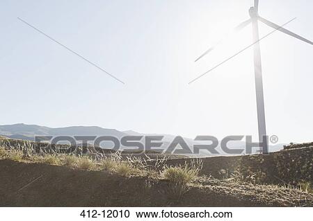 Wind turbine spinning in rural landscape View Large Photo Image Stock Image - Wind turbine spinning in rural landscape. Fotosearch