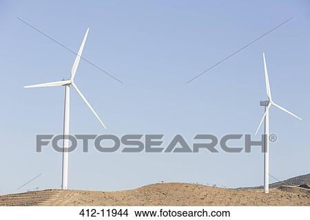 Wind turbines spinning in rural landscape View Large Photo Image Picture - Wind turbines spinning in rural landscape. Fotosearch