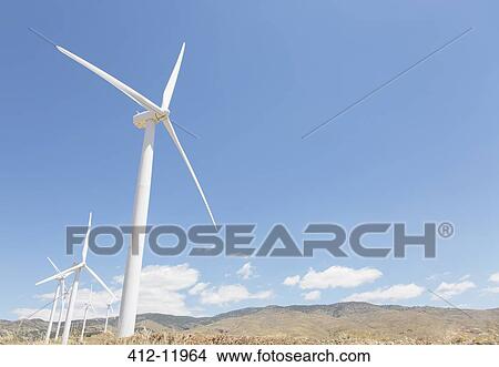 Picture - Wind turbines spinning in rural landscape. Fotosearch