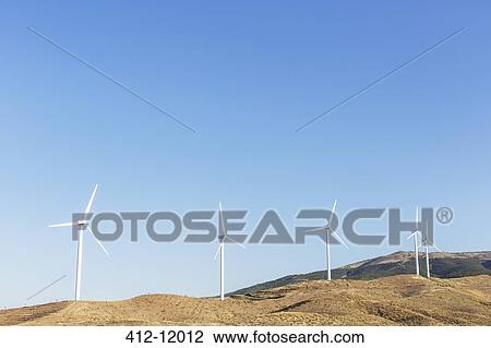 Wind turbines spinning in rural landscape View Large Photo Image Stock Image - Wind turbines spinning in rural landscape. Fotosearch