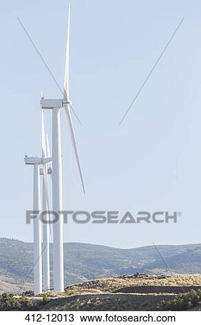 Wind turbines spinning in rural landscape View Large Photo Image Stock Image - Wind turbines spinning in rural landscape. Fotosearch