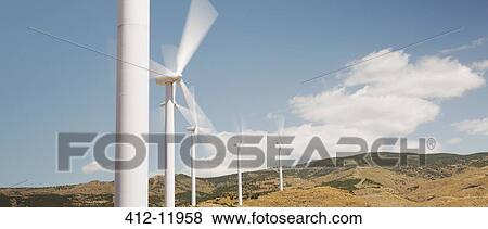 Wind turbines spinning in rural landscape View Large Photo Image Stock Photo - Wind turbines spinning in rural landscape. Fotosearch