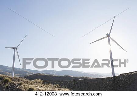 Wind turbines spinning in rural landscape View Large Photo Image Stock Photo - Wind turbines spinning in rural landscape. Fotosearch