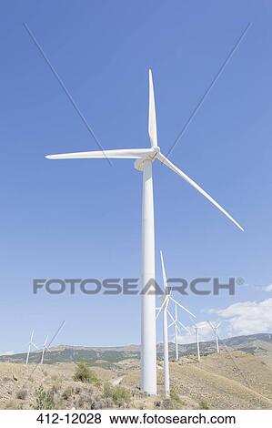 Wind turbines spinning in rural landscape View Large Photo Image Stock Photo - Wind turbines spinning in rural landscape. Fotosearch