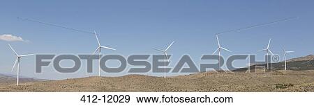 Wind turbines spinning in rural landscape View Large Photo Image Stock Photo - Wind turbines spinning in rural landscape. Fotosearch