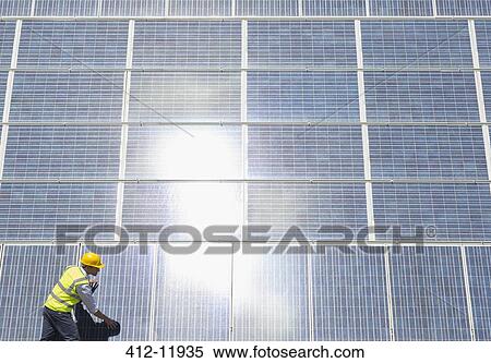 Worker examining solar panels View Large Photo Image Stock Photography - Worker examining solar panels. Fotosearch