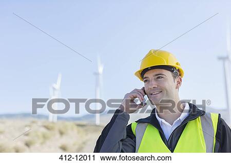 Worker using walkie talkie in rural landscape View Large Photo Image Stock Image - Worker using walkie talkie in rural landscape. Fotosearch